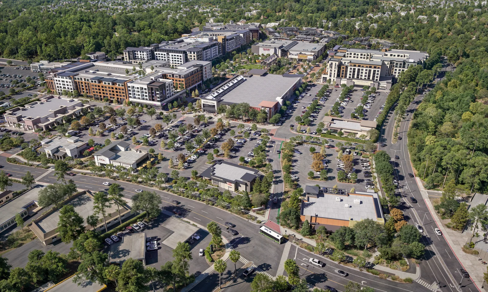 Aerial of Northgate Town Square in San Rafael with apartments, retail and parking among hills