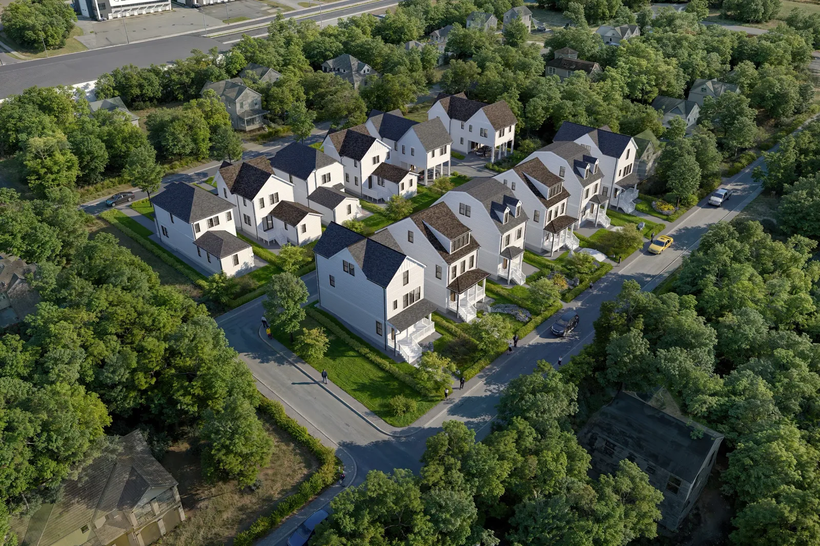 Aerial of white gabled townhomes among mature trees at Prince & Duke in Nashville