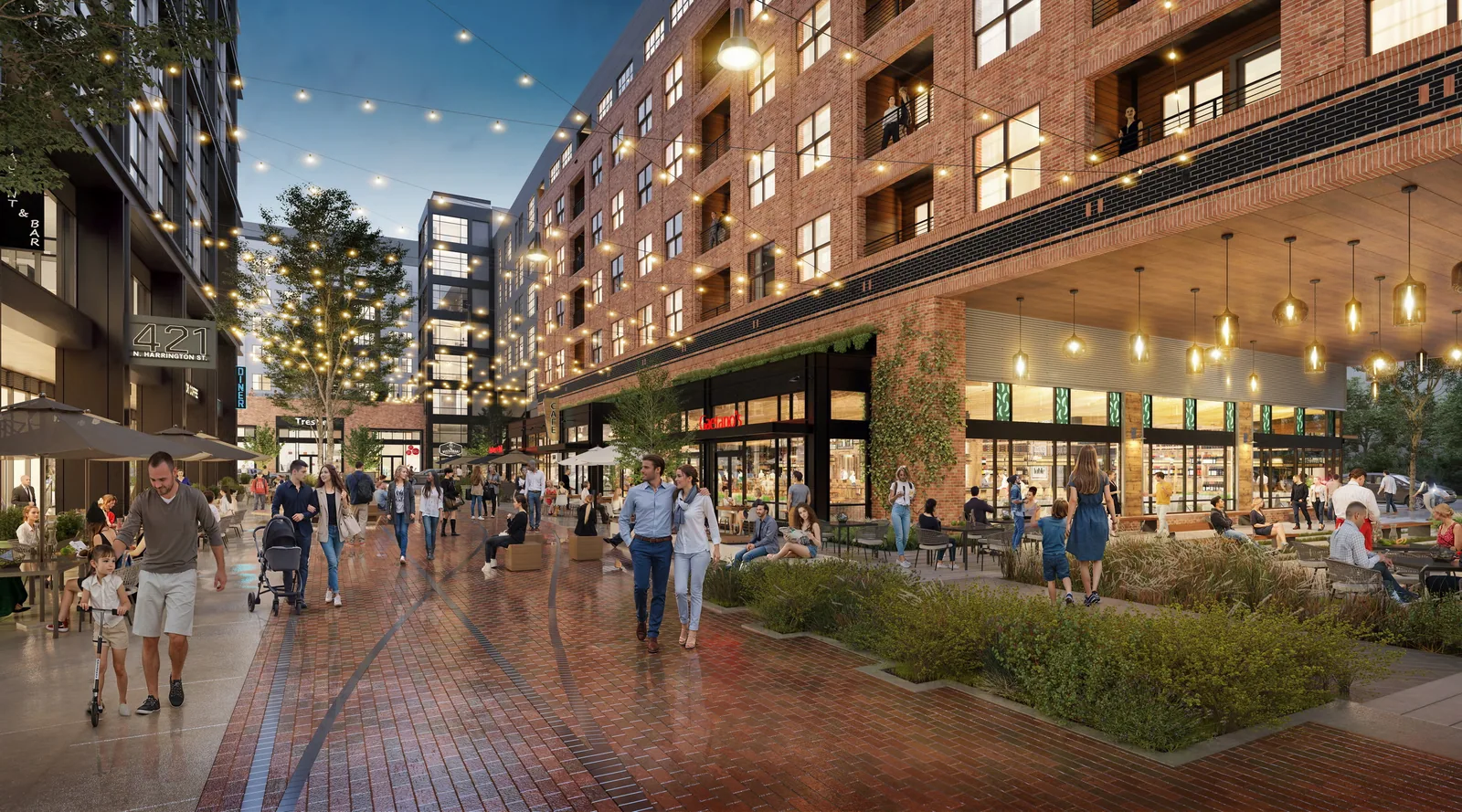 Brick pedestrian street with patios and string lights at The Line in downtown Raleigh