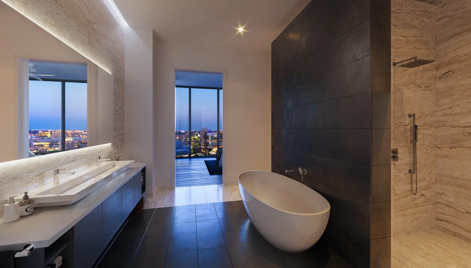 Stone bath with freestanding tub and night city view in a residence at The Victor, Dallas