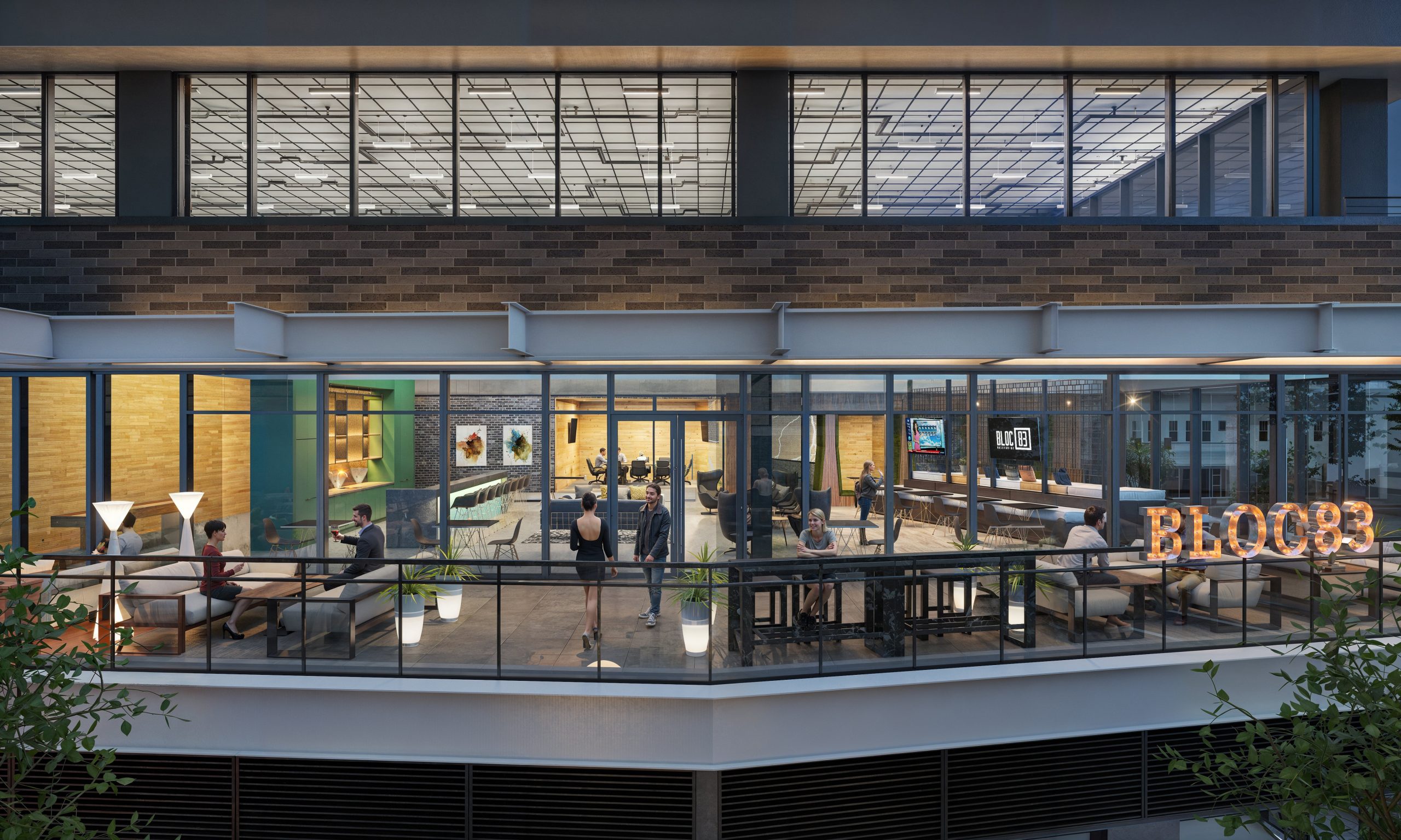 621 Hillsborough Raleigh office terrace night rendering by Bogza.com. A glowing twilight view of the elevated outdoor tenant terrace, showcasing illuminated BLOC83 marquee letters, comfortable lounge seating, and a view into the modern indoor office space.