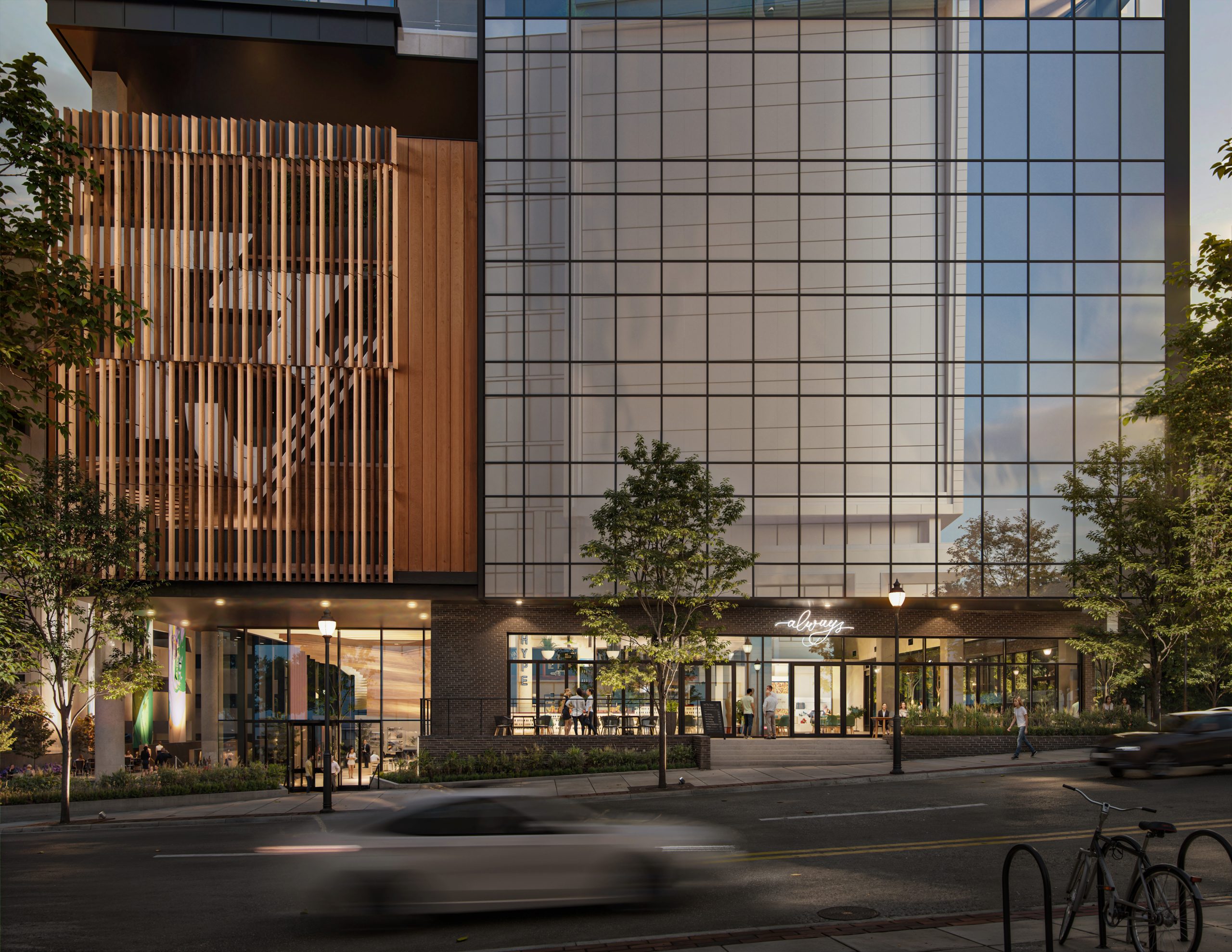 Tower 3 at Bloc 83 Raleigh retail storefront exterior rendering by Bogza.com. A stunning twilight street-level view of the modern commercial building, highlighting a warmly lit ground-floor retail space, expansive glass windows, and the striking wood-slat design of the parking podium above.