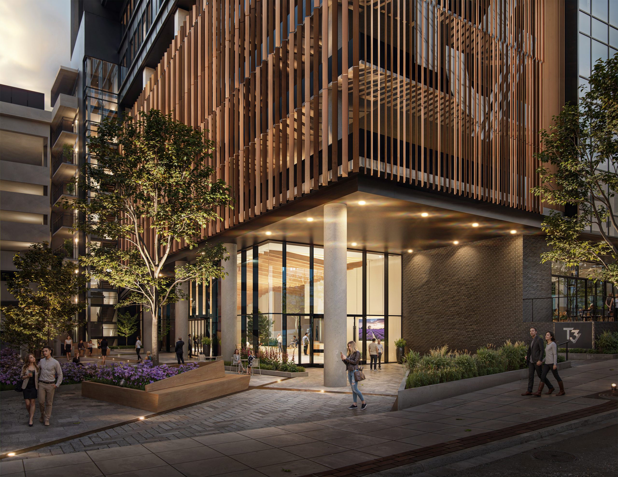 Tower 3 at Bloc 83 Raleigh office lobby entrance exterior rendering by Bogza.com. A twilight view of the main entrance to the Class A office tower, showcasing a modern glass lobby enclosure under a prominent overhang, surrounded by landscaped planters, integrated outdoor seating, and warm lighting.