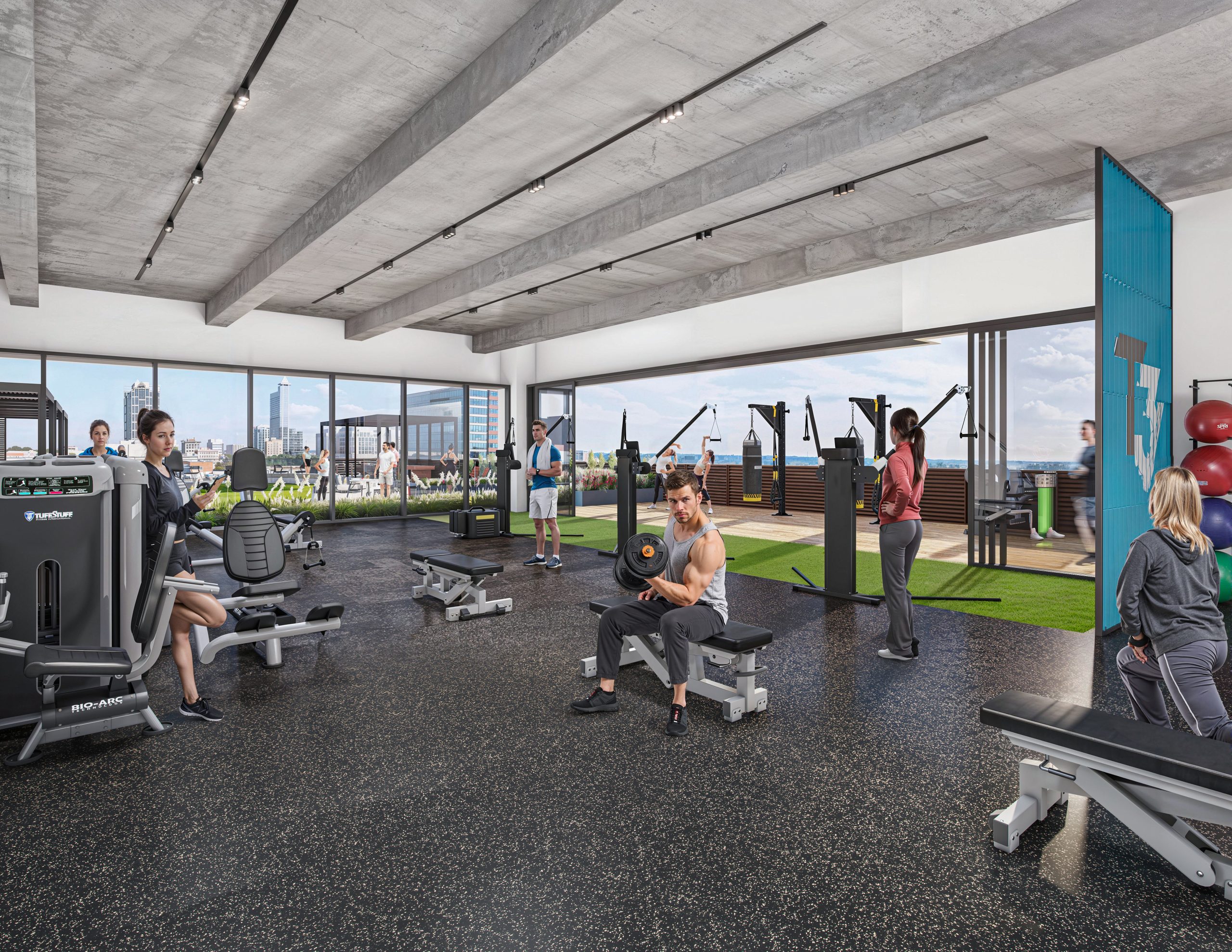 Tower 3 at Bloc 83 Raleigh office fitness center interior rendering by Bogza.com. A bright, state-of-the-art tenant gym amenity showcasing modern weight machines and free weights, exposed concrete ceilings, and massive open glass doors seamlessly connecting to an outdoor turf workout terrace.