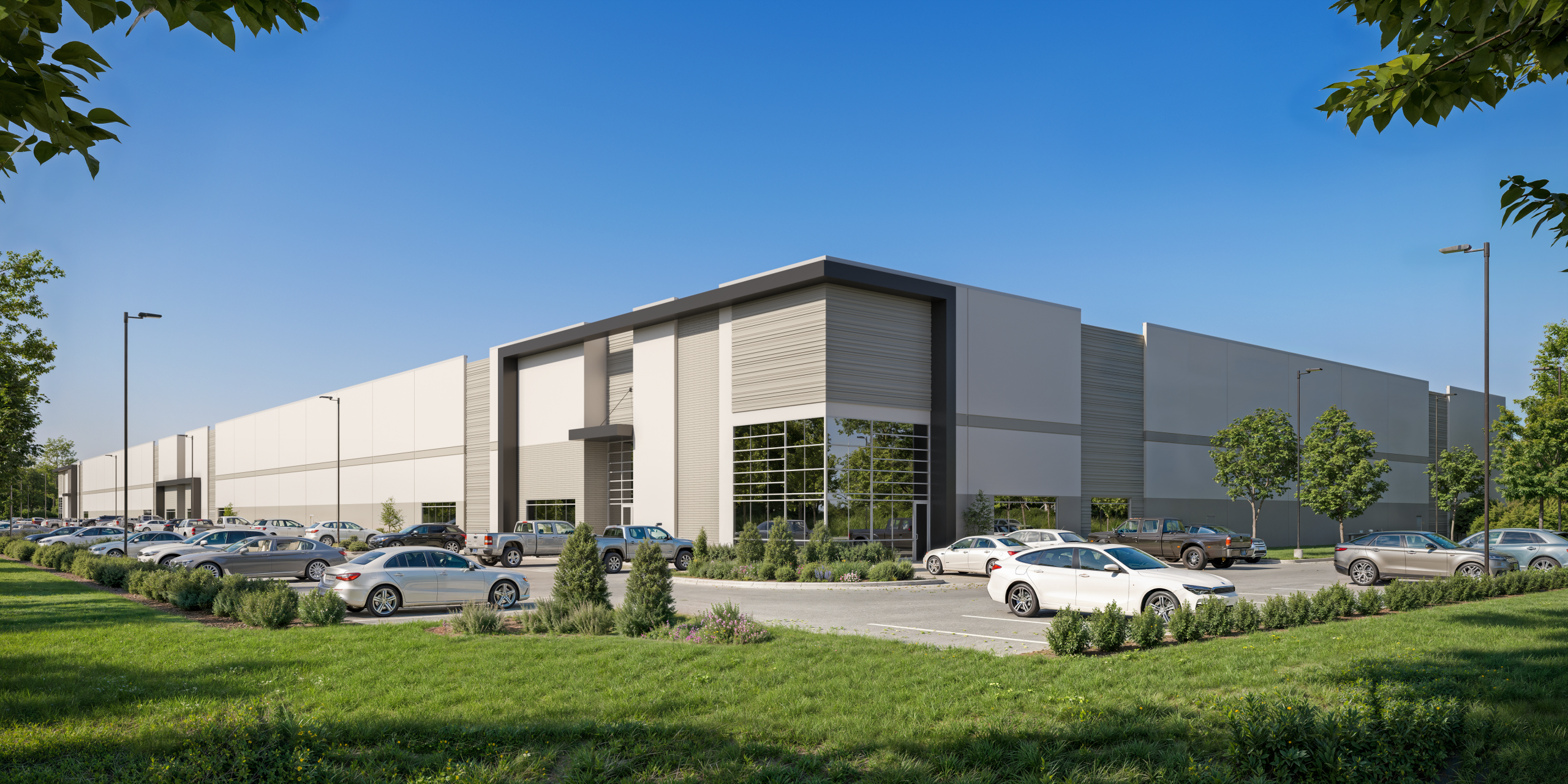 Landis Ridge North Carolina commercial warehouse exterior rendering by Bogza.com. A bright daytime street-level view of the modern Class A industrial facility, highlighting a sleek facade with an oversized glass entrance, concrete and metal paneling, ample auto parking, and landscaped grounds.