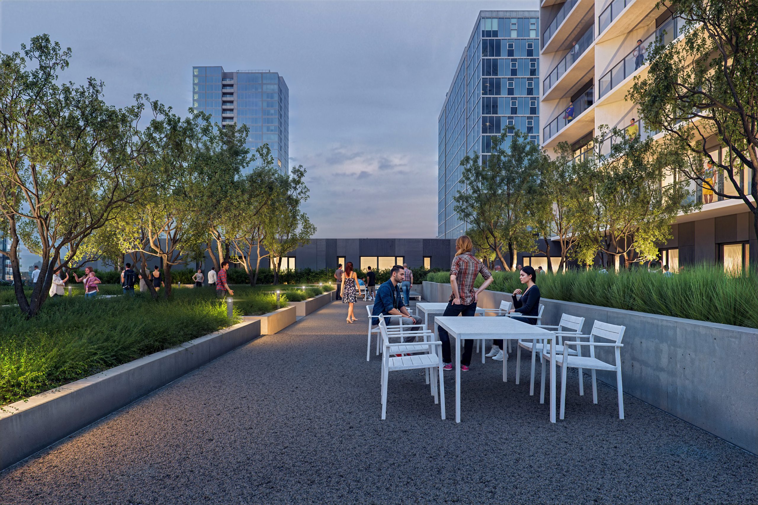 Block 20 Vista Pearl Portland landscaped terrace architectural rendering by Bogza.com. A twilight view of the modern condo building's expansive outdoor amenity deck, featuring a gravel walking path, outdoor dining tables, lush trees, and residents enjoying the evening skyline.
