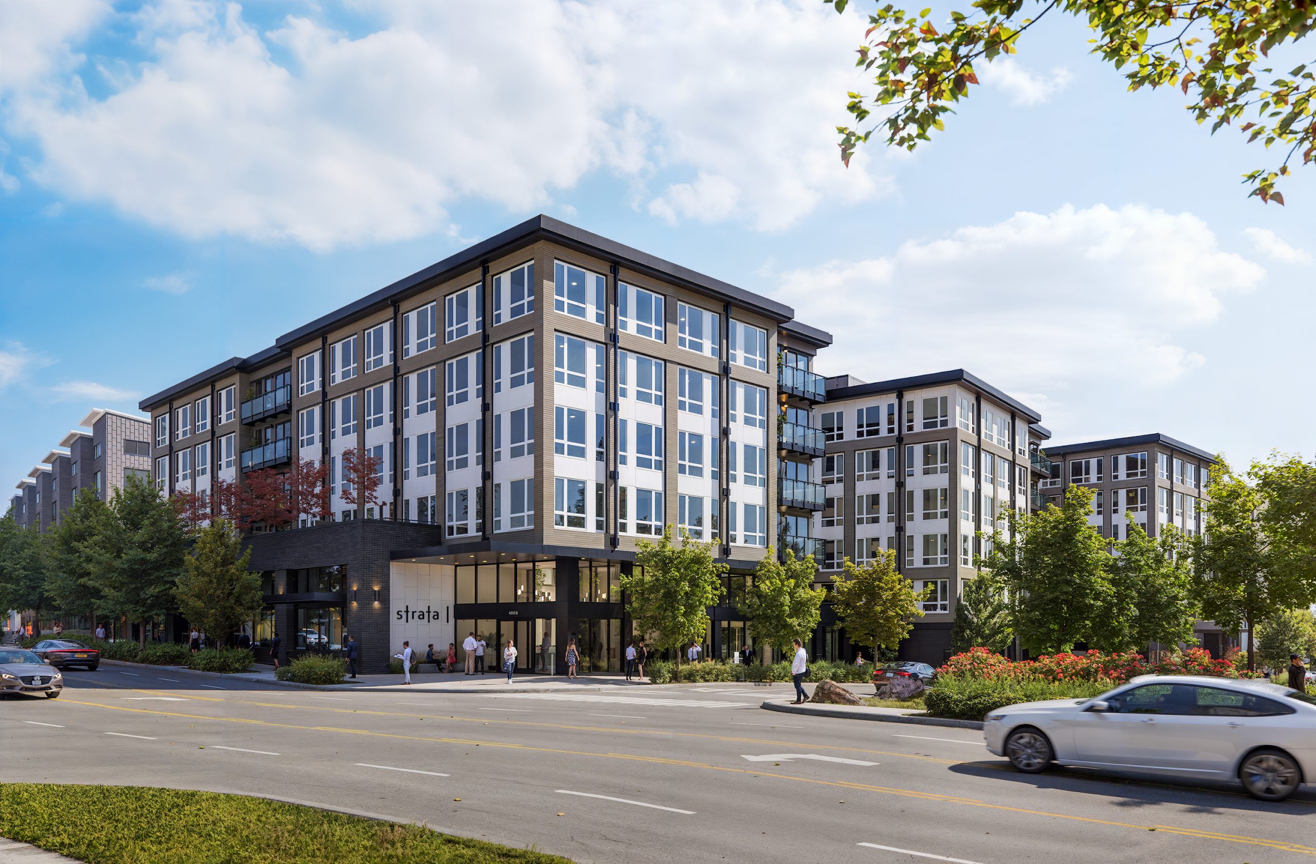 Broadstone Strata Seattle architectural exterior rendering by Bogza.com. A bright daytime street-level view of the 7-story luxury apartment building near University Village, featuring a modern facade with white and dark grey panels, brick accents, expansive windows, street trees, and pedestrian activity.