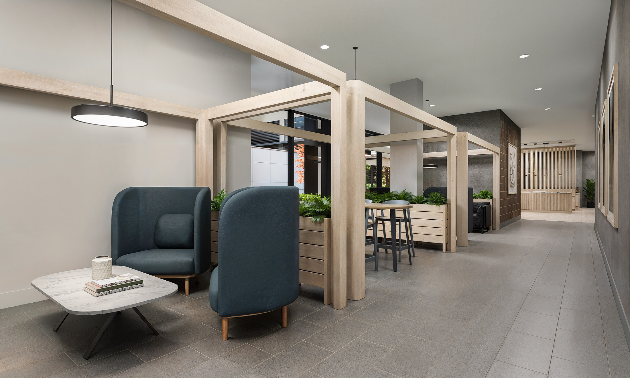 Broadstone Strata Seattle coworking lounge interior architectural rendering by Bogza.com. A contemporary amenity space designed for remote work, featuring semi-private wooden focus pods with comfortable seating, modern lighting, and a pathway leading toward the main lobby.