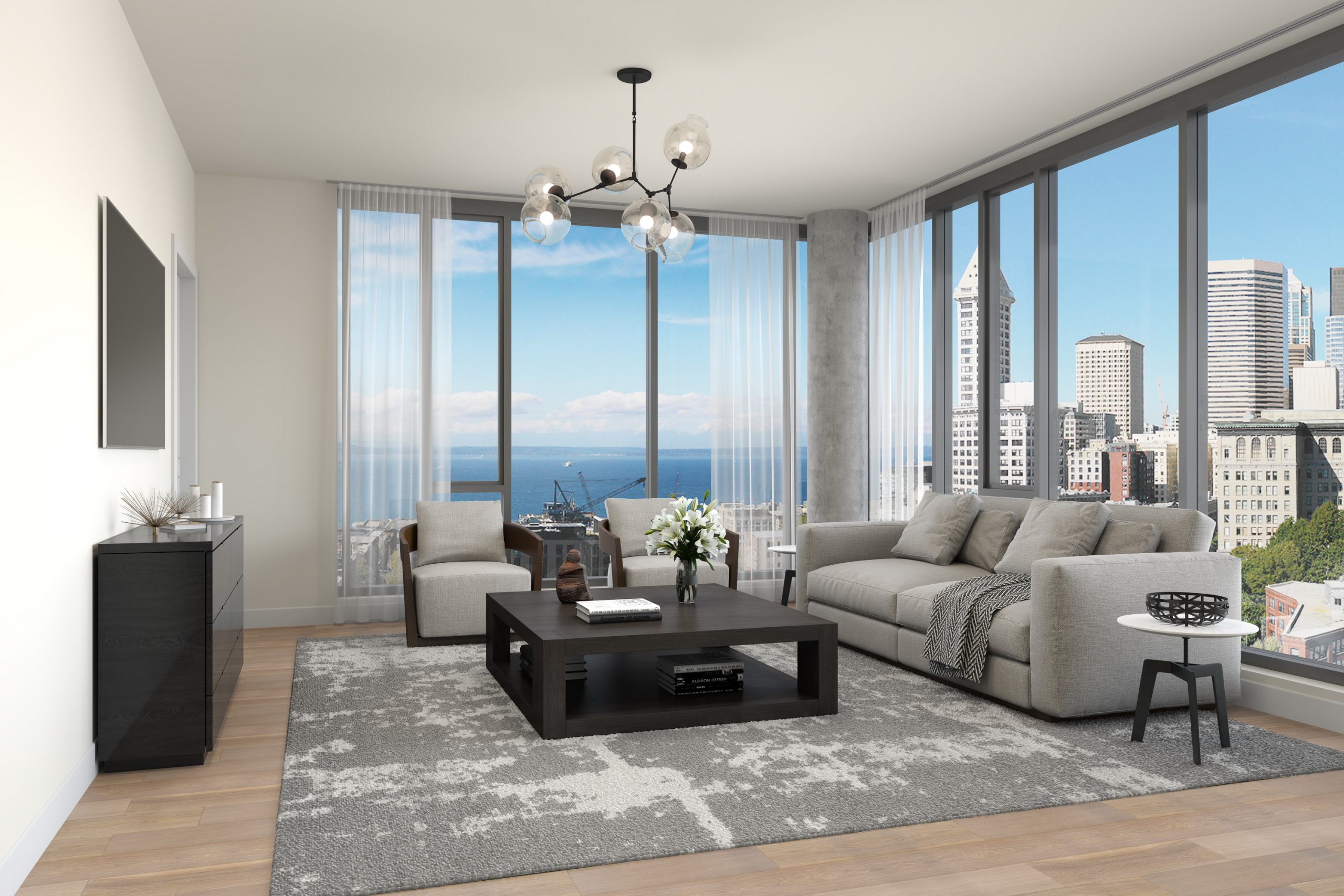 KODA Condominiums Seattle luxury apartment living room interior rendering by Bogza.com. A sophisticated, light-filled condominium residence showcasing hardwood floors, a modern chandelier, cozy seating, a home workspace, and floor-to-ceiling windows framing unobstructed views of Elliott Bay.