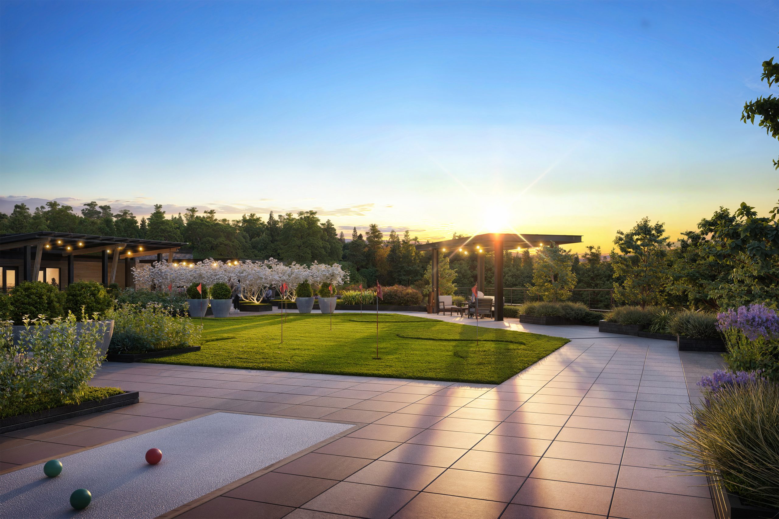 The Springs at Lake Oswego rooftop bocce court and putting green rendering by Bogza.com. A stunning sunset view of the luxury retirement community's vibrant outdoor amenity deck, showcasing recreational spaces, a wooden pergola, string lights, and expansive views of the Oregon landscape.