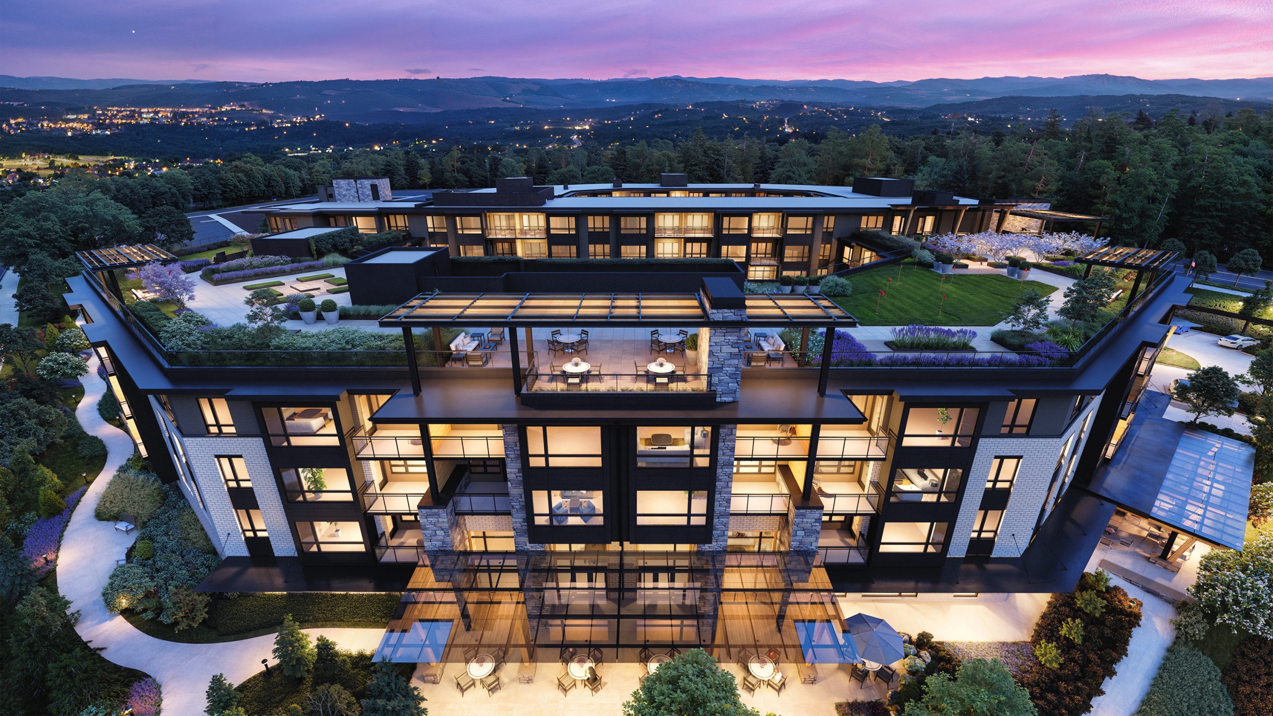 The Springs at Lake Oswego rooftop terrace aerial architectural rendering by Bogza.com. A high-angle dusk view focusing on the 5-story building's multi-level outdoor amenity decks, glass entrance canopies, illuminated apartments, and sweeping views of the distant hills.