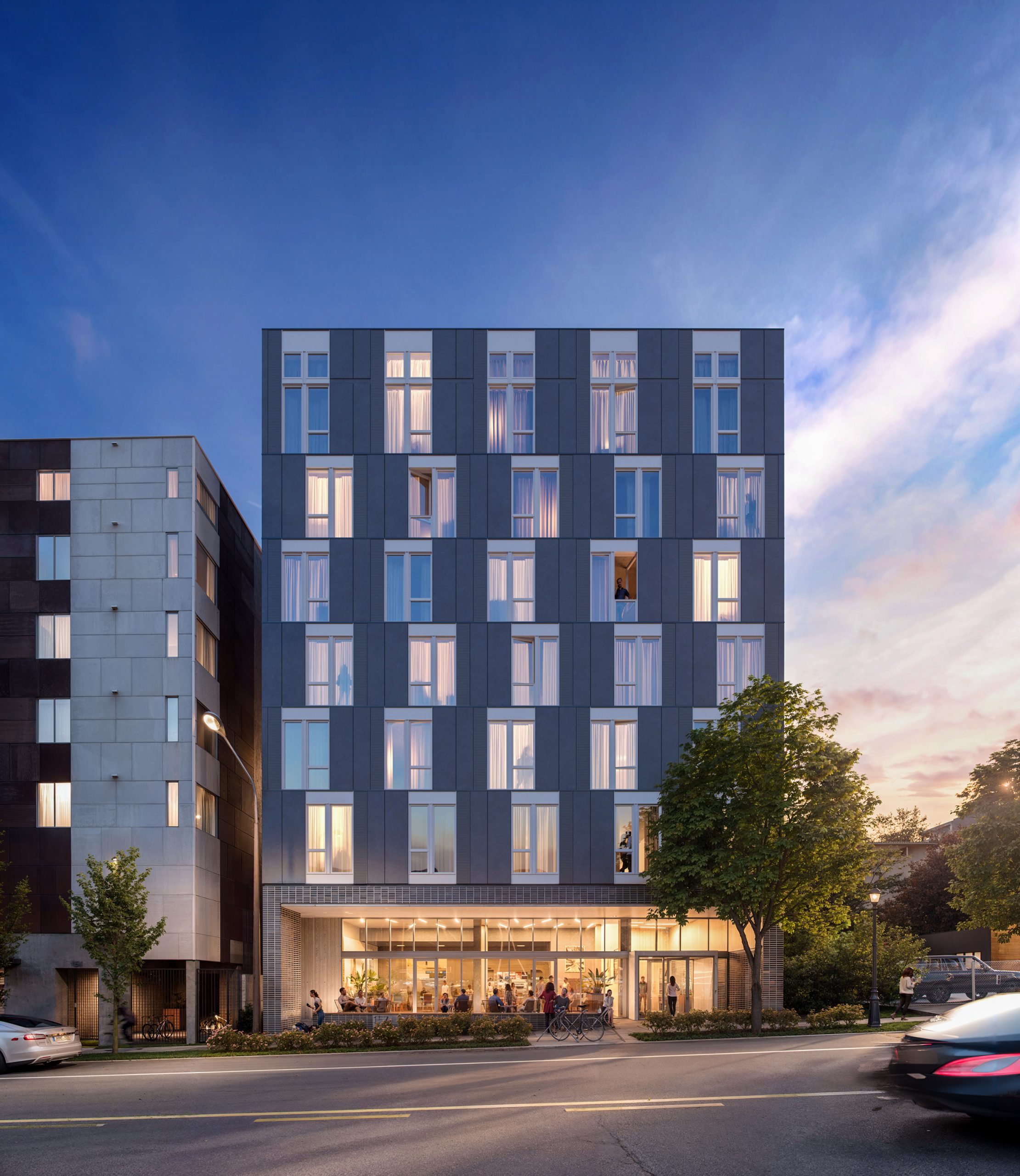 Sound Flats Seattle architectural exterior rendering by Bogza.com. A twilight street-level view of the modern 7-story apartment building on First Hill, showcasing a dark grey facade with large windows, a warm, illuminated ground-floor retail space, street trees, bicycles, and active pedestrians.