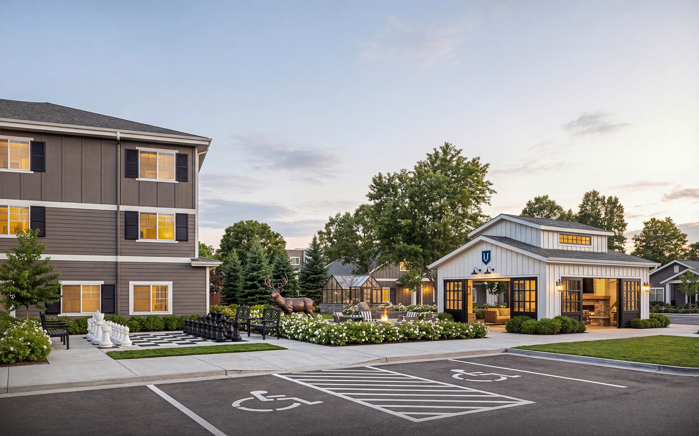 University Village senior living courtyard and outdoor patio rendering by Bogza.com. A dusk view of the luxury community's outdoor amenity spaces, featuring a large outdoor chess set, a fire pit area, an open-air covered pavilion with a fireplace, and a bronze elk sculpture.